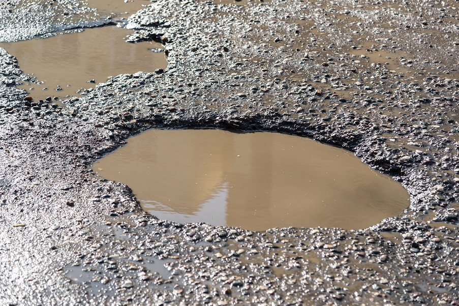 A driveway with potholes