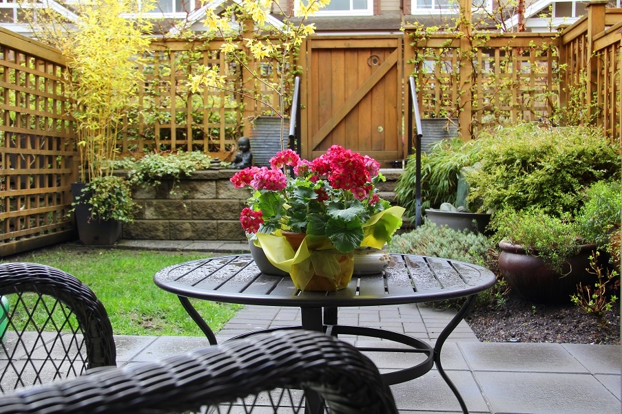 A small garden with a table and chairs