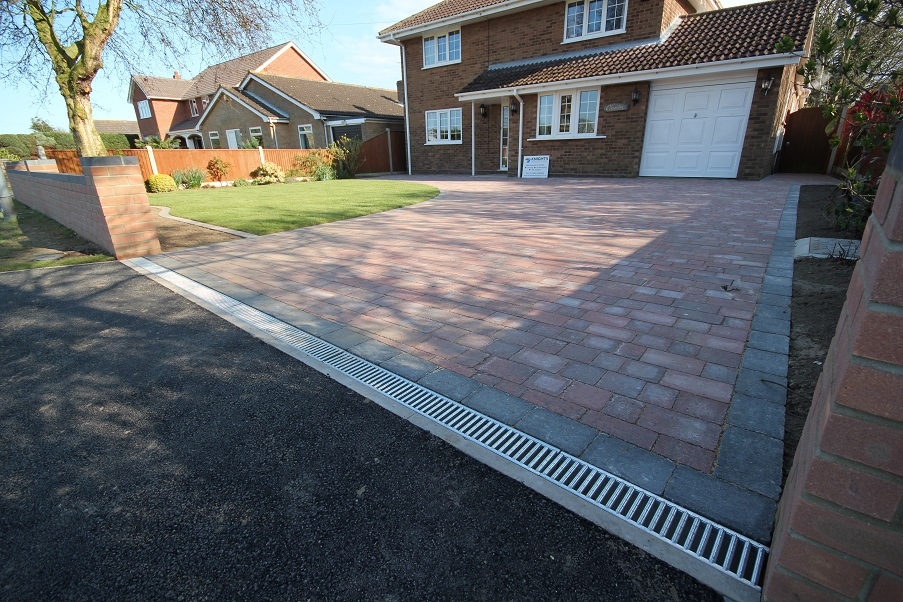 A new driveway with drainage at the bottom