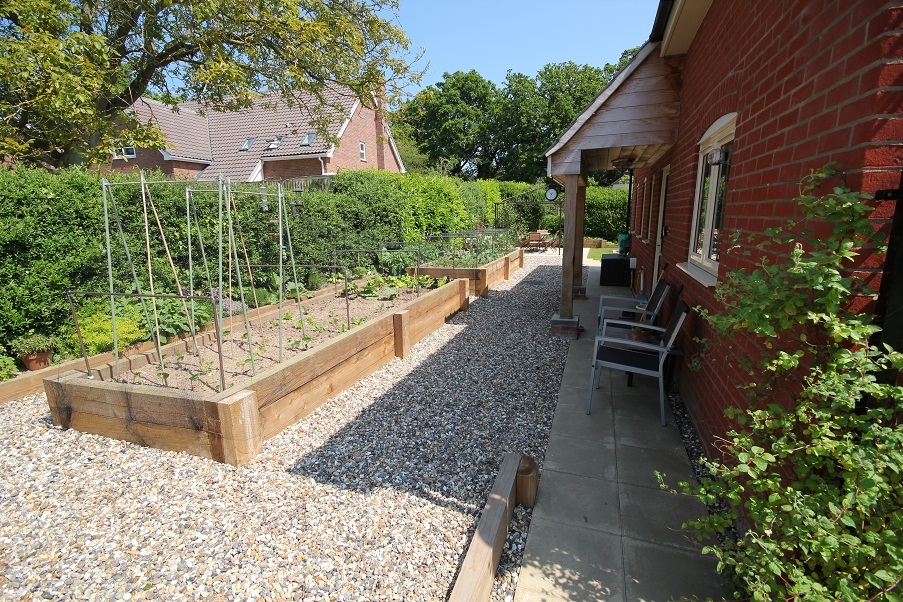 Raised flower beds and vertical planters we installed last year.