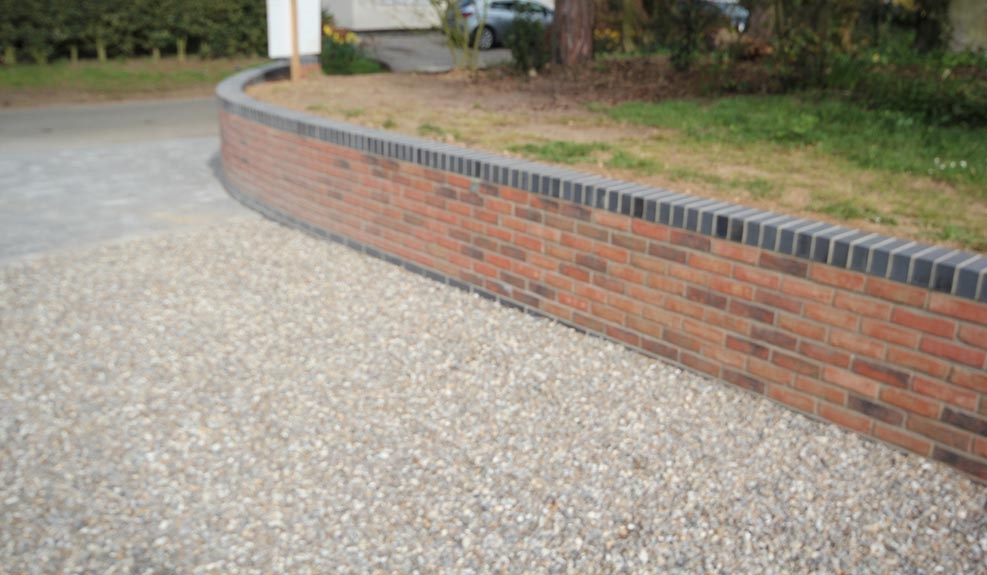 Shingle driveway resurfacing wall